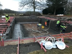 Pump concrete for walls and floor of outdoor pool
