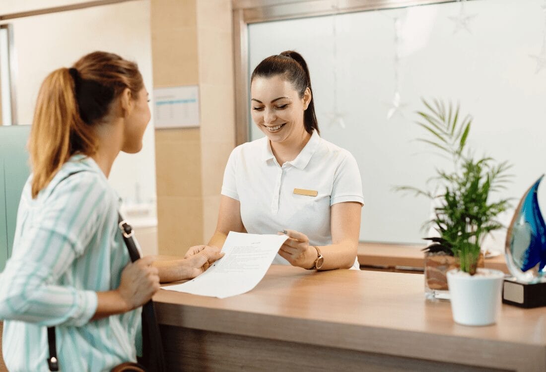 Why-Spa-Designs-Should-Include-Fantastic-Break-Rooms-For-Staff A receptionist easily helping a customer after enjoying her lunch in the break room for staff.
